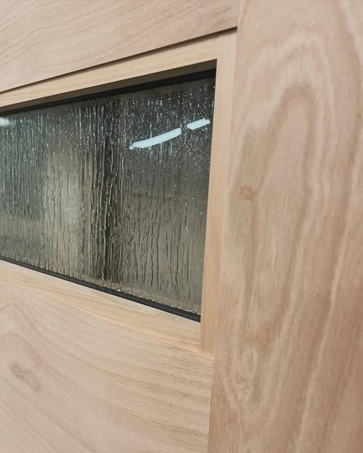 Close-up of textured glass set in a rectangular wood door opening